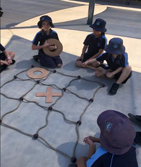 Students playing a giant Noughts and Crosses game